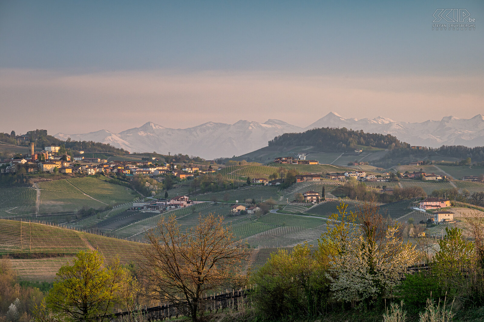 Langhe region - Sunset The beautiful Langhe Roero Monferrato region with the many famous vineyards and picturesque villages on the hills and in the distance some snowy Alpine peaks Stefan Cruysberghs
